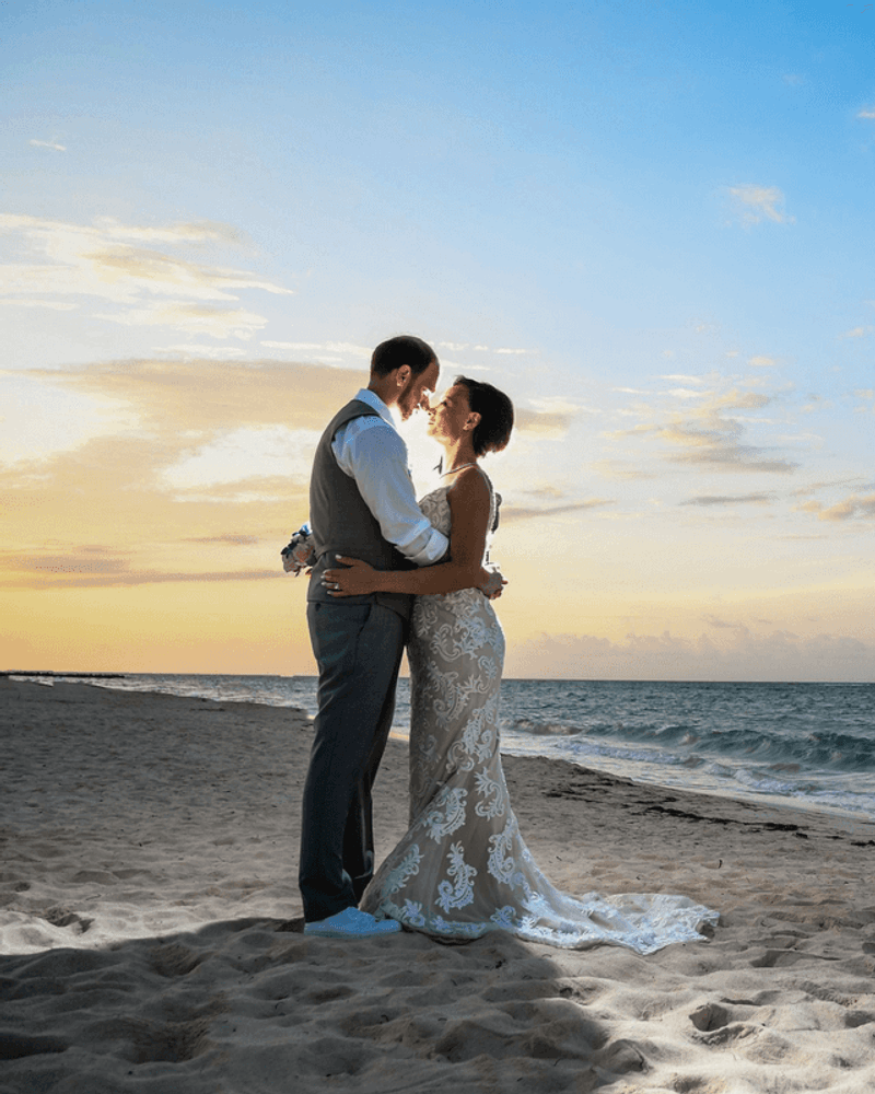 Couple embracing at sunset by the coast — marriage proposal mood shot